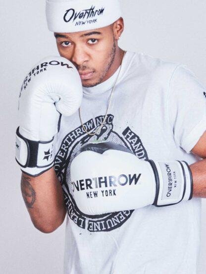 Male wearing overthrow white tshirt and white boxing gloves